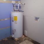 Water heater up to code on electrical, height off floor, and drainage